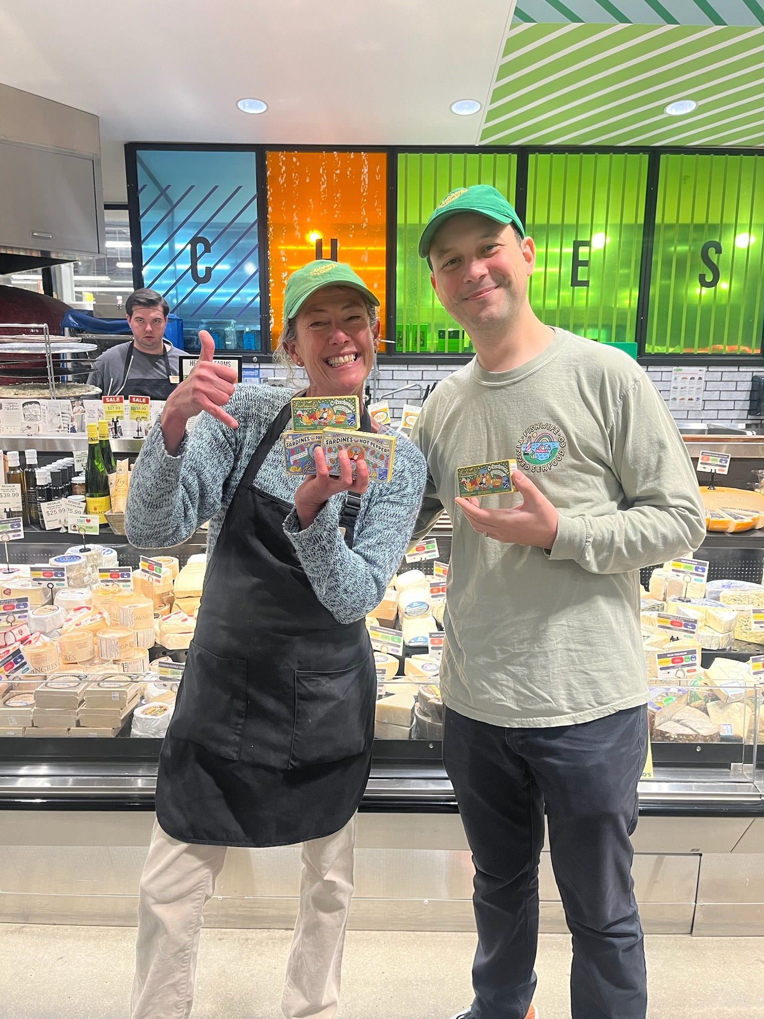 Fishwife in the cheese section of a grocery store.