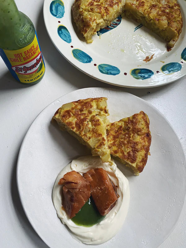 Tortilla de Patatas with Creme Fraiche, Smoked Salmon, and green hot sauce